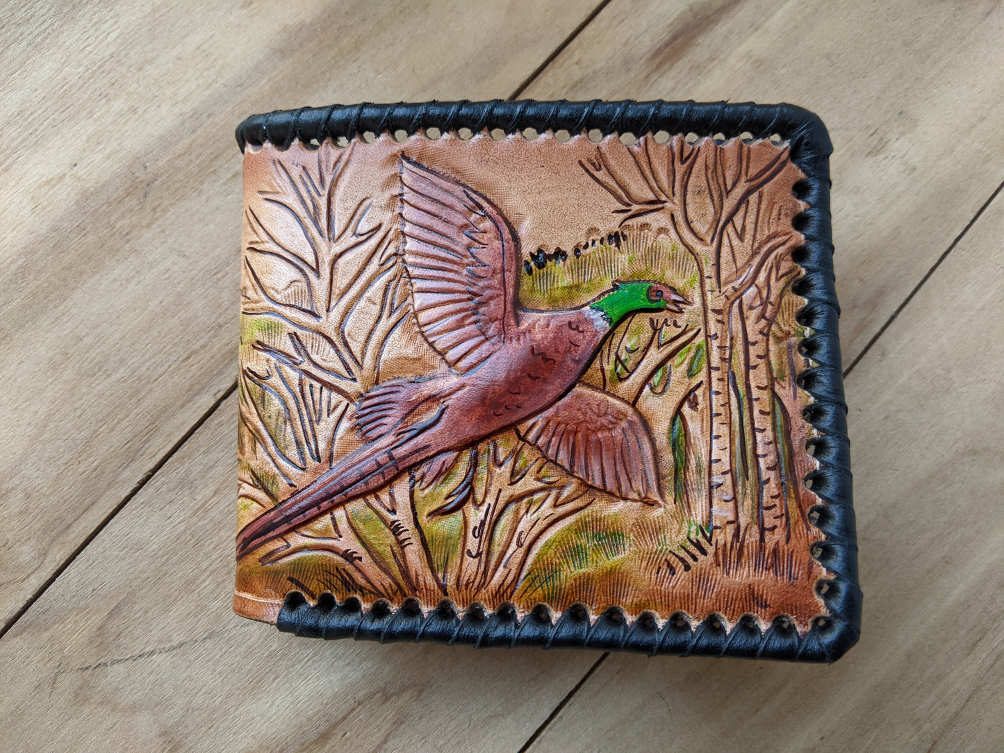 Shop the Hunter's Leather Wallet with pheasant hunting scene and rifle design. Handmade, RFID-protected, and perfect for outdoorsmen or as a Father's Day gift.