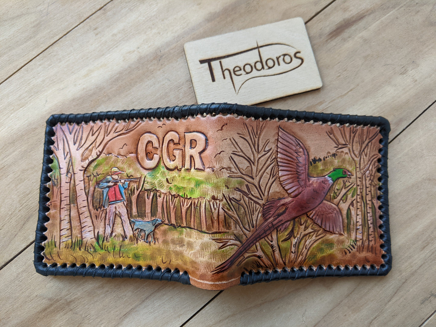 Shop the Hunter's Leather Wallet with pheasant hunting scene and rifle design. Handmade, RFID-protected, and perfect for outdoorsmen or as a Father's Day gift.