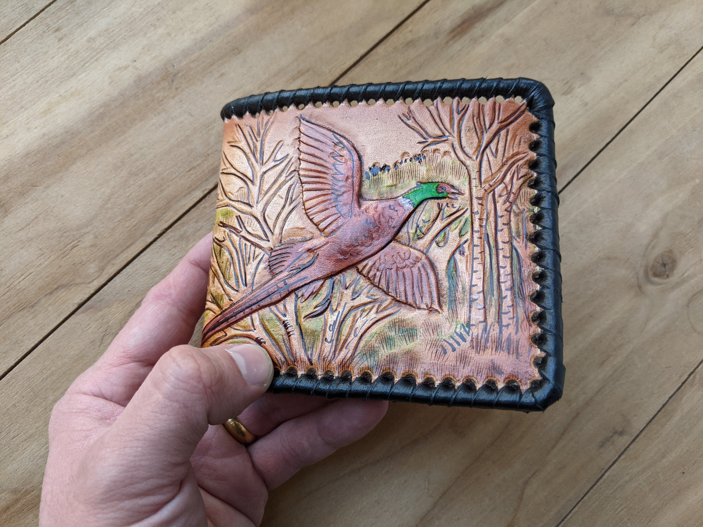Shop the Hunter's Leather Wallet with pheasant hunting scene and rifle design. Handmade, RFID-protected, and perfect for outdoorsmen or as a Father's Day gift.