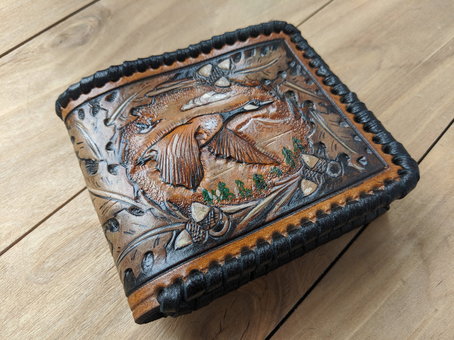 Shop the Goose Hunting Leather Wallet! Featuring oak leaf embossing and RFID protection, this handmade wallet is a perfect Father's Day gift for outdoorsmen.
