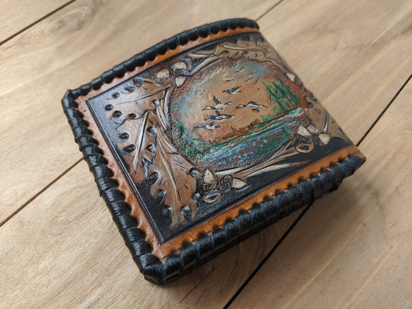 Shop the Goose Hunting Leather Wallet! Featuring oak leaf embossing and RFID protection, this handmade wallet is a perfect Father's Day gift for outdoorsmen.