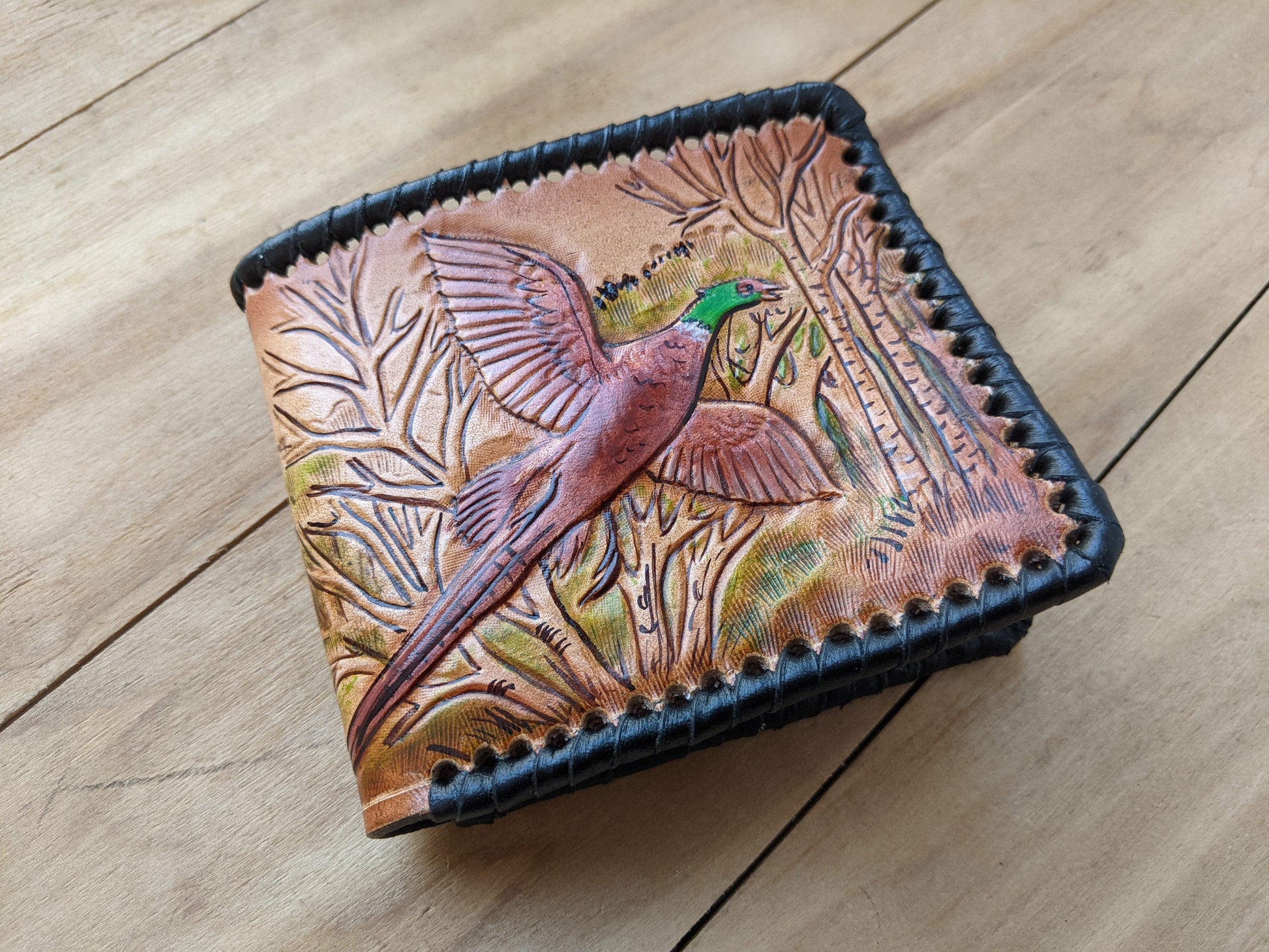 Shop the Hunter's Leather Wallet with pheasant hunting scene and rifle design. Handmade, RFID-protected, and perfect for outdoorsmen or as a Father's Day gift.
