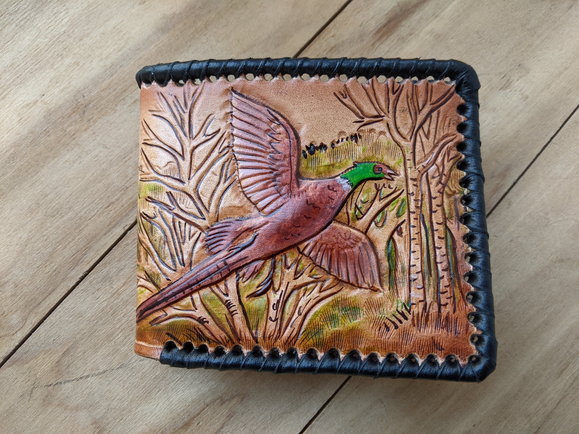 Shop the Hunter's Leather Wallet with pheasant hunting scene and rifle design. Handmade, RFID-protected, and perfect for outdoorsmen or as a Father's Day gift.