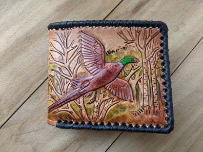 Shop the Hunter's Leather Wallet with pheasant hunting scene and rifle design. Handmade, RFID-protected, and perfect for outdoorsmen or as a Father's Day gift.