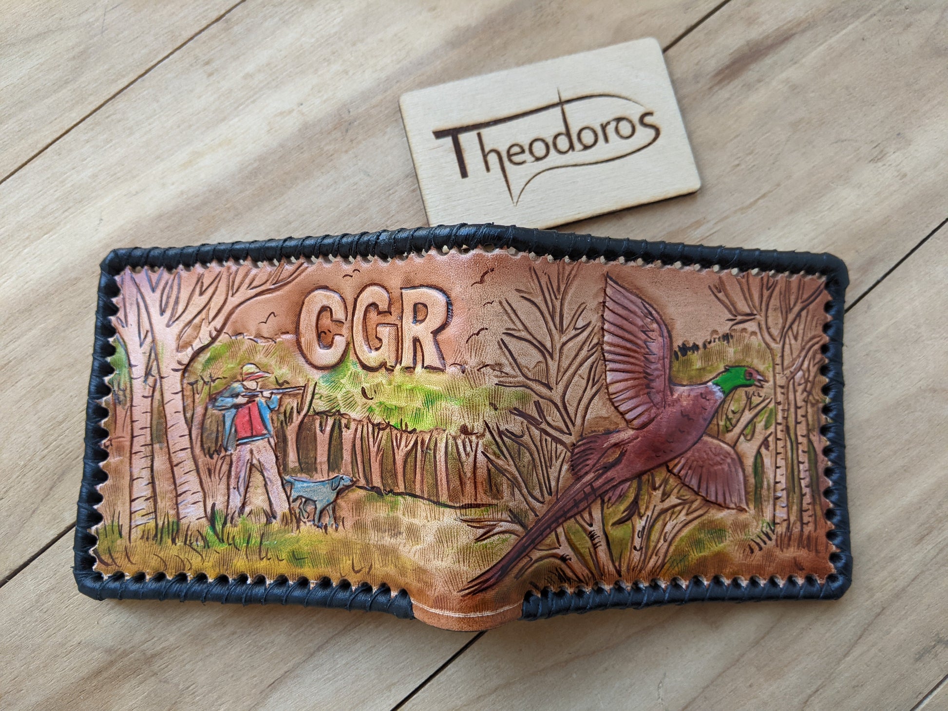 Shop the Hunter's Leather Wallet with pheasant hunting scene and rifle design. Handmade, RFID-protected, and perfect for outdoorsmen or as a Father's Day gift.