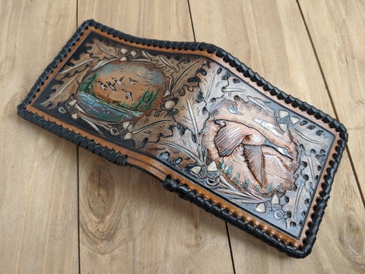 Shop the Goose Hunting Leather Wallet! Featuring oak leaf embossing and RFID protection, this handmade wallet is a perfect Father's Day gift for outdoorsmen.