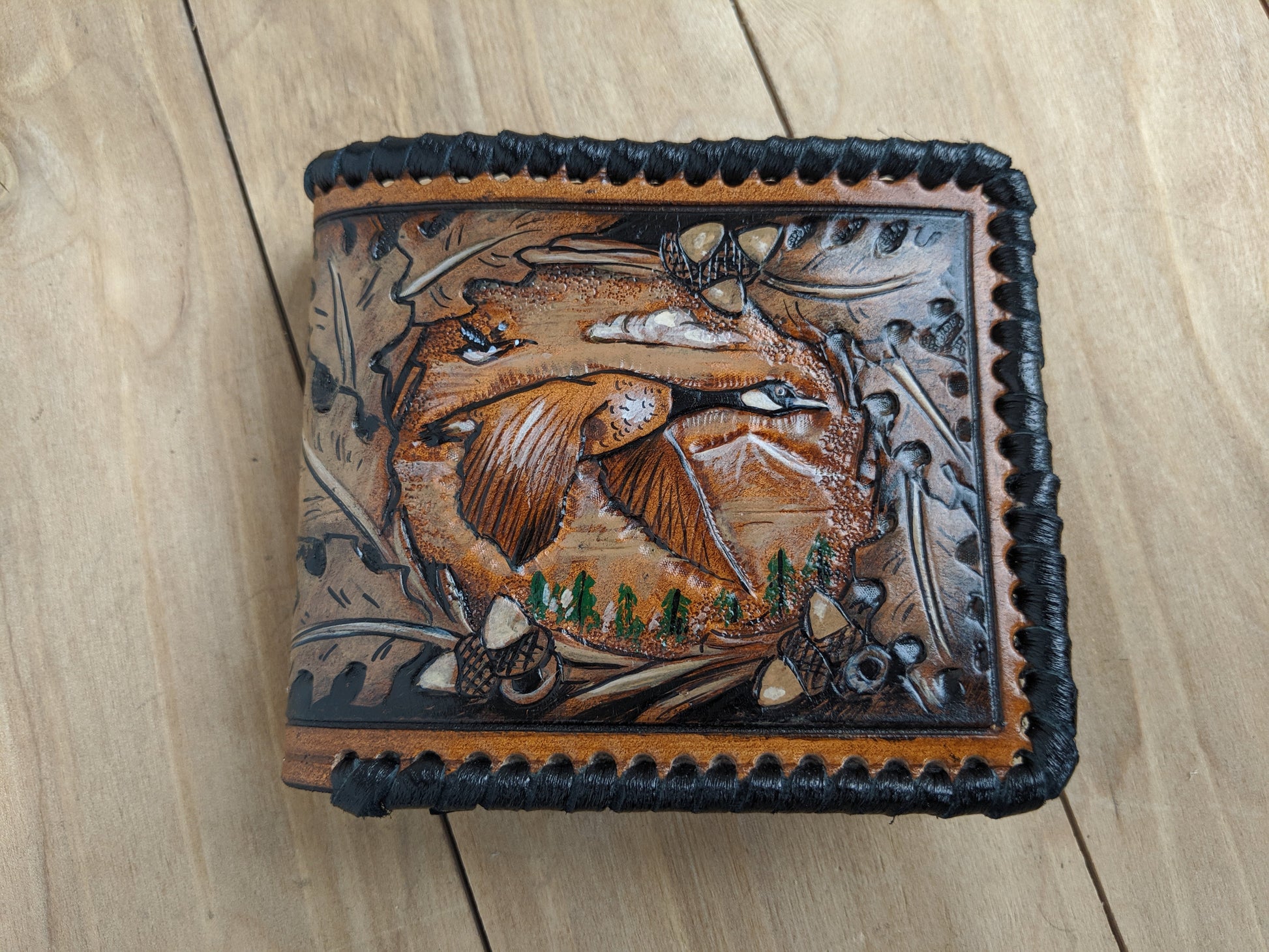 Shop the Goose Hunting Leather Wallet! Featuring oak leaf embossing and RFID protection, this handmade wallet is a perfect Father's Day gift for outdoorsmen.