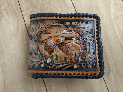 Shop the Goose Hunting Leather Wallet! Featuring oak leaf embossing and RFID protection, this handmade wallet is a perfect Father's Day gift for outdoorsmen.