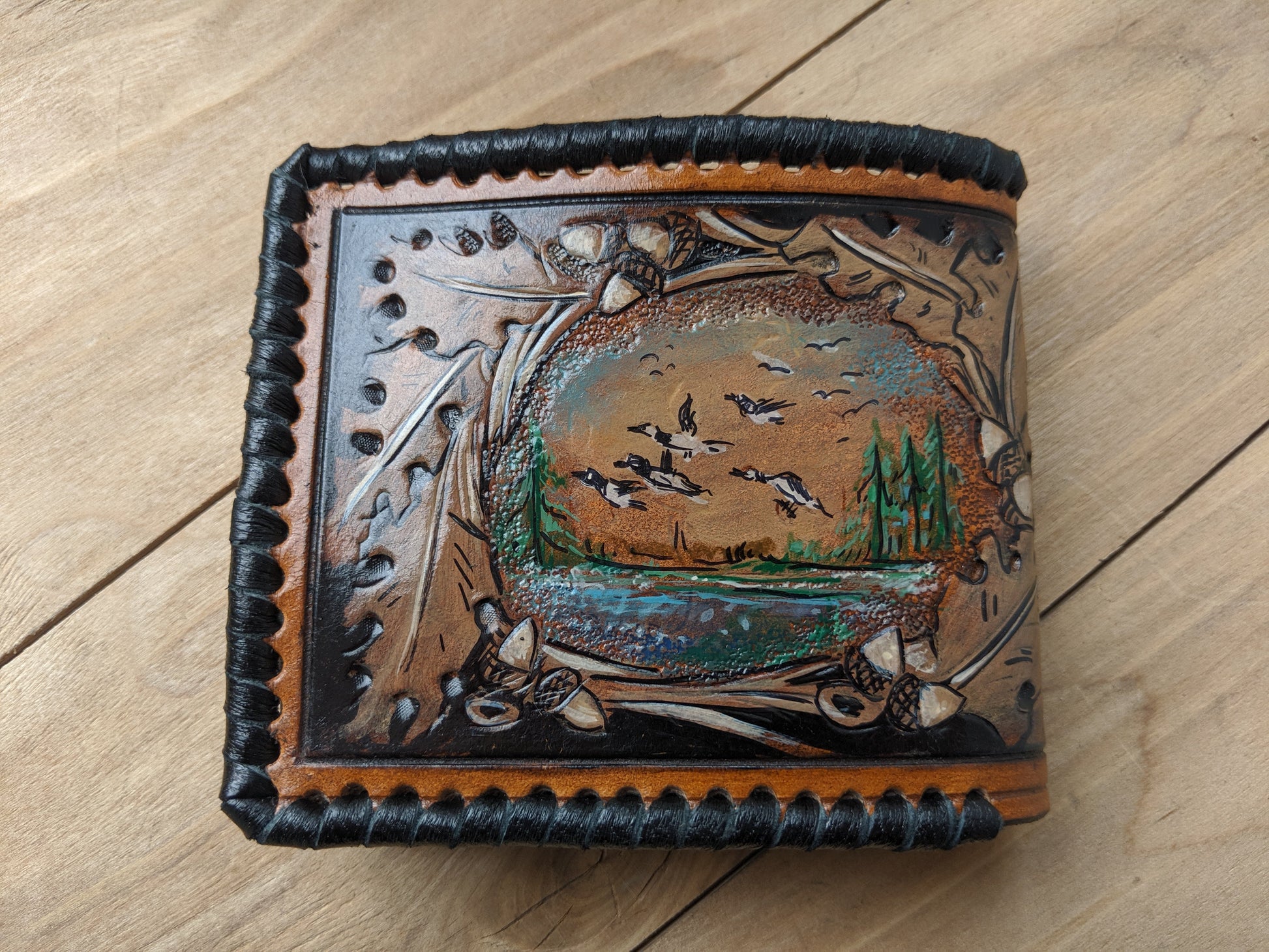 Shop the Goose Hunting Leather Wallet! Featuring oak leaf embossing and RFID protection, this handmade wallet is a perfect Father's Day gift for outdoorsmen.