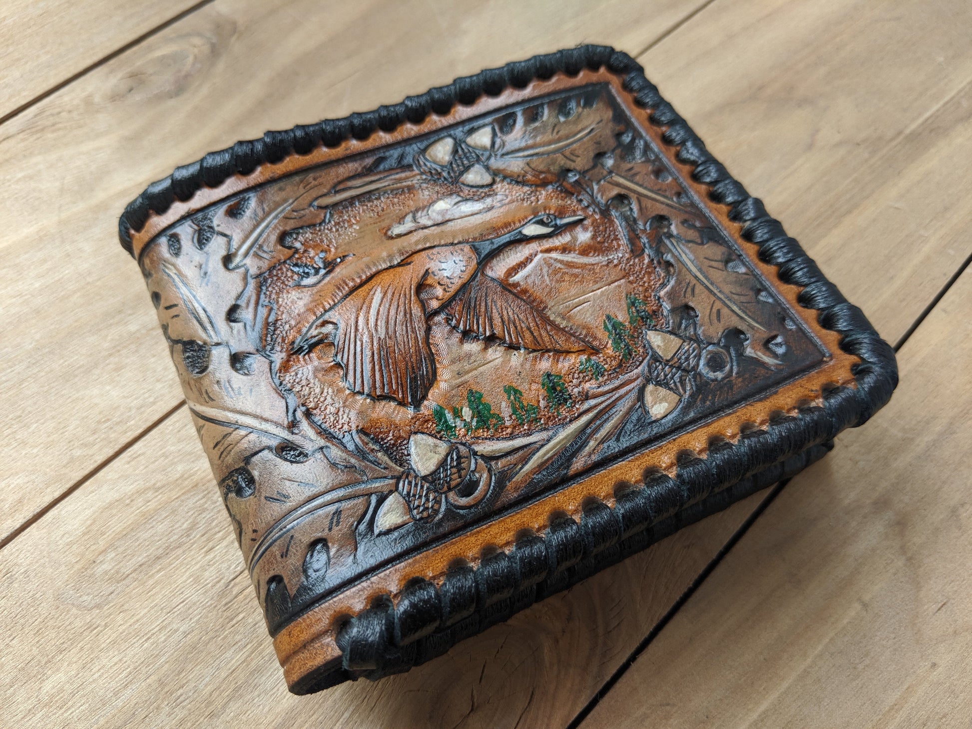 Shop the Goose Hunting Leather Wallet! Featuring oak leaf embossing and RFID protection, this handmade wallet is a perfect Father's Day gift for outdoorsmen.